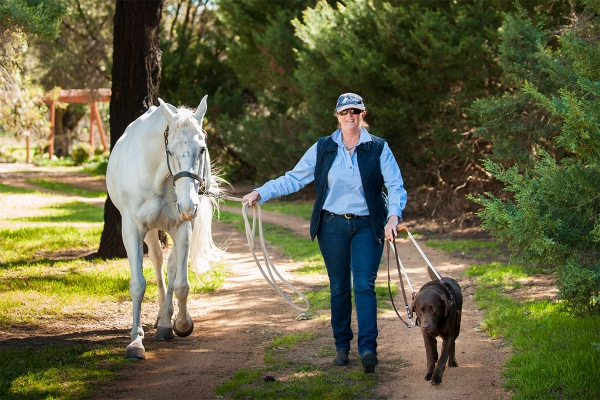 Sue-Ellen with her horse and her Guide Dog